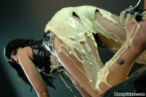 splosh and wam porn. girl in tight leather shorts covers herself in custard